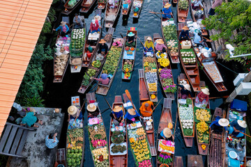 Ayutthaya Bangkok Thailand traditional holiday floating market visitor shop on river selling farmer food and fruit vegetable colorful flowers and clothes on the wooden boat in the morning
