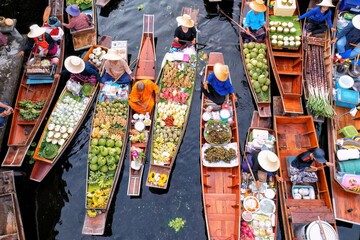 Ayutthaya Bangkok Thailand traditional holiday floating market visitor shop on river selling farmer food and fruit vegetable colorful flowers and clothes on the wooden boat in the morning
