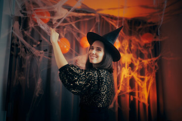 Happy Woman Decorating her Home for Halloween. Cheerful lady arranging her room with festive...