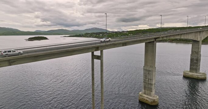 Finnsnes Norway v2 dramatic low level drone fly along gisund bridge with cars driving on cantilever road bridge crossing gisundet strait towards silsand village - Shot with Mavic 3 Cine - June 2022