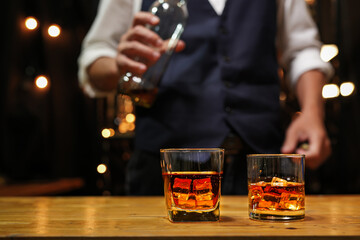 Bartender pouring Whiskey, on  bar,