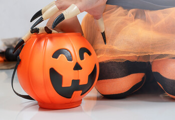 A child in a Halloween costume with candy bucket