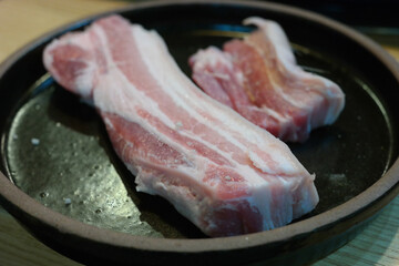 Fresh thick raw pork is served