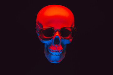 human skull wearing sunglasses in red and blue neon light on a dark background