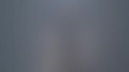 Blurred footage, fogged glass in the shower where the hand appears - Powered by Adobe