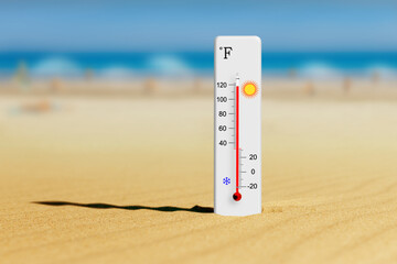 Sea coast at hot summer day. Fahrenheit scale thermometer in the sand shows plus 118 degrees