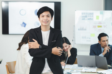 Close-up shot of a man meeting in a startup company meeting room, he is a marketing worker attending meetings with executives and employees to plan a sales boost. Sales management concept.