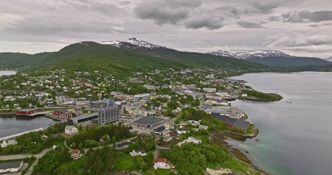 Finnsnes Norway v4 cinematic pull out shot reveals beautiful landscape of small quaint town surrounded by fjord gisundet strait and pristine snowy mountianscape - Shot with Mavic 3 Cine - June 2022