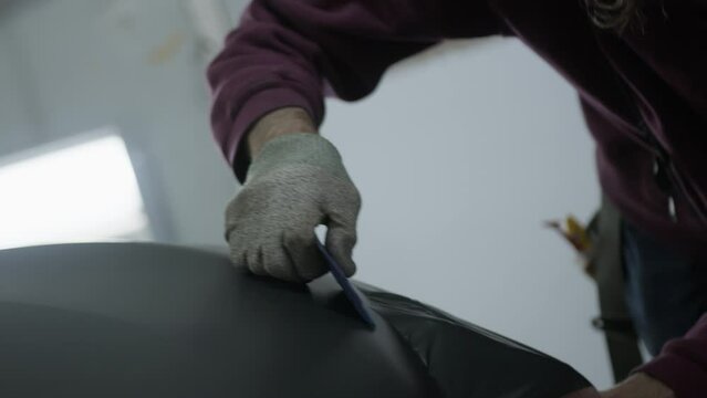 Vehicle wrap installation with squeegee.