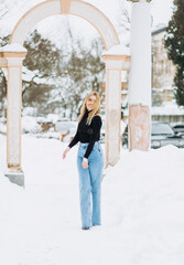 Fototapeta premium Close-up winter portrait of young woman with blond hair in the park