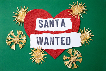 Santa wanted written on white paper strips,  Santa for hire sign