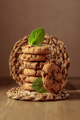 Chocolate cookies with mint on a wooden table.