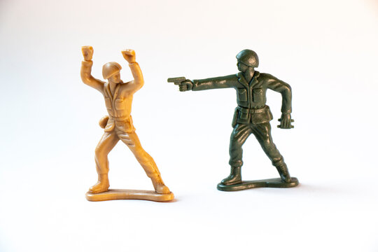 Two toy soldiers fighting conceptual