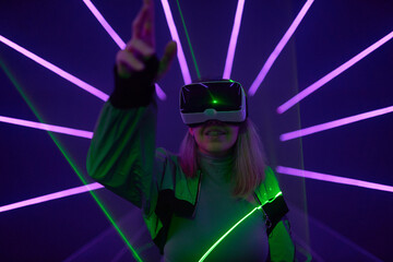 Fototapeta na wymiar Woman is using virtual reality headset to access in metaverse.