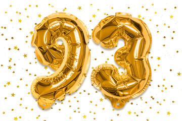The number of the balloon made of golden foil, the number ninety-three on a white background with sequins. Birthday greeting card with inscription 93. Numerical digit, Celebration event.