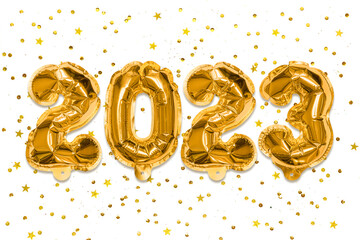 Golden foil balloons made numbers 2023 on a white background with sequins. New Year's card. Happy new year celebration party. Greetings and congratulation concept.