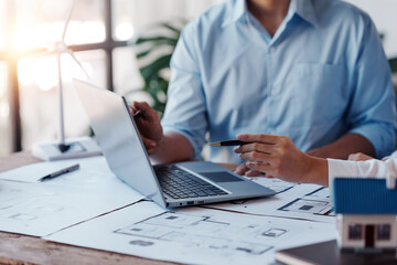 Project planning meetings with engineer or architect working together to model home and use engineering tools to create model and blueprint at work.