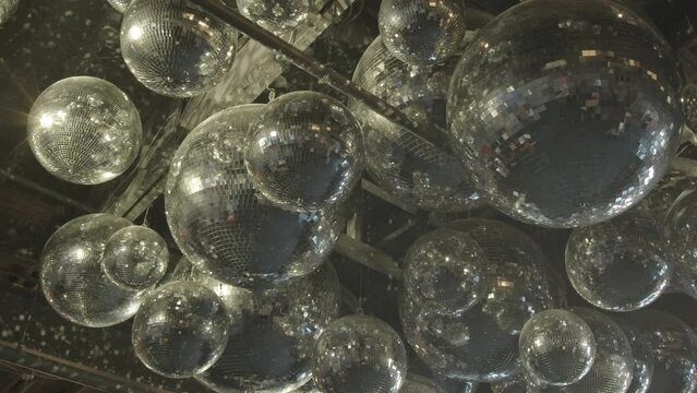 Close Up Shot Of Suspended Silver Mirror Disco Balls