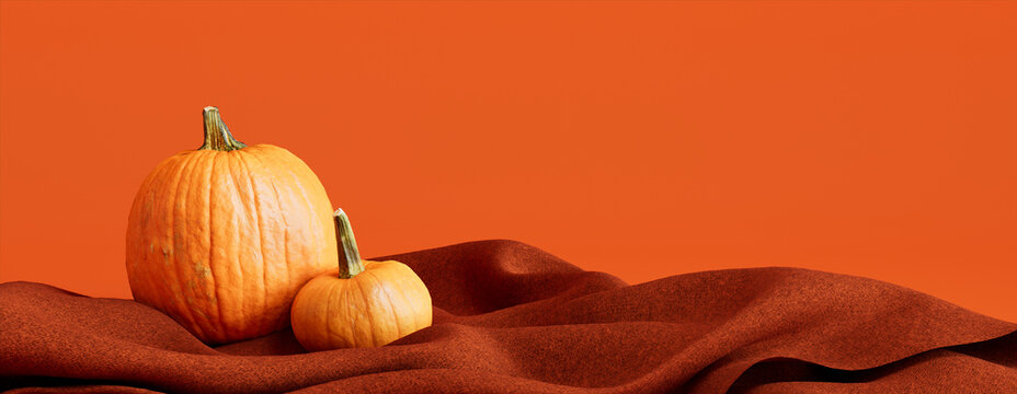 Pumpkins with Orange colored Blanket. Fall themed Background with copy-space.