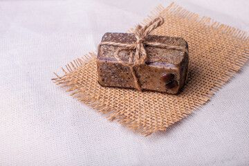 Piece of handmade soap with coffee beans. Spa concept for massage and relax.