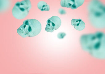 Pastel mint skulls fly or float in the air on a pink background. Creepy and scary Halloween concept. Minimal abstract visual creative composition.