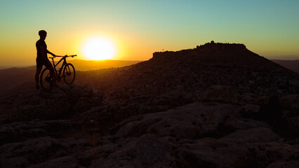 Fototapeta premium Cycling in harsh conditions, enjoying the magnificent view and successful cyclist
