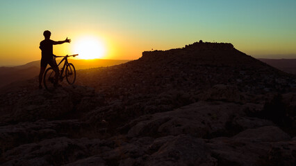 Cycling in harsh conditions, enjoying the magnificent view and successful cyclist