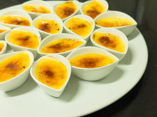 A cup of creamblulee dessert