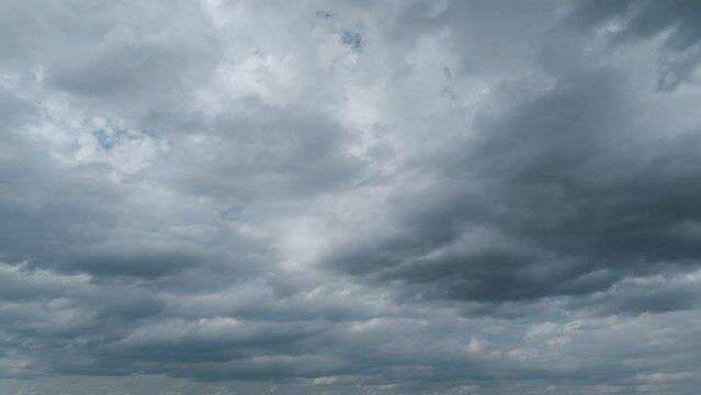 Sky with white fluffy rain clouds on the blue sky. Dramatic cloudscape, amazing sky. Timelapse.