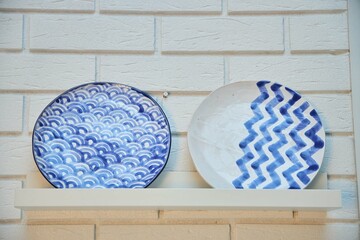 Two plates with blue patterns as an interior decoration. Oriental decor.