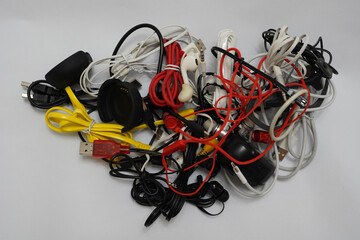 tangled cables of different types on a white background