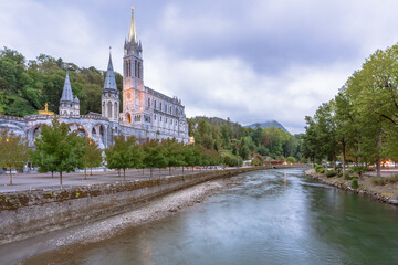 Scenic view of Lourdes River Ousse and the Sanctuary in France. Long Exposure shot