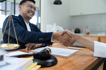 lawyer or attorneys shaking hand with client after consultation discussing a contract agreement customer at courtroom, judge service concept