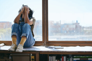 Burnout, anxiety and fatigue creative student frustrated lack of inspiration, studying or learning problem in university classroom. College woman by window crying, stress or mental health depression