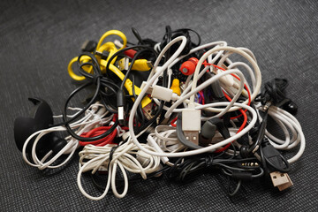 tangled cables of different types on a black background