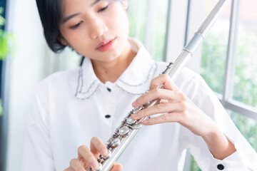 Flute :  A closeup of hands of a musician playing the flute, detail shot, classical music, wind...