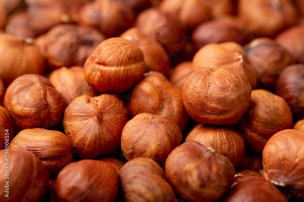 Wall mural Heap of hazelnuts close-up. Peeled nuts. Hazelnut isolated on white background.