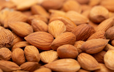Apricot kernels peeled close-up as a background. Apricot grains heap isolated on white background.