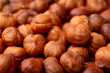 Heap of hazelnuts close-up. Peeled nuts. Hazelnut isolated on white background.