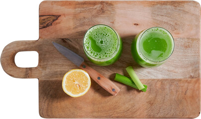 Top view of two glasses with celery smoothie on wooden board