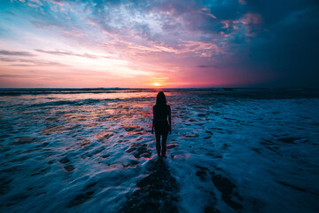 Woman standing in front of an amazing sunset