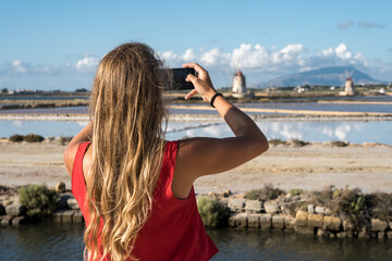 Tourist Taking Selfie at salt flats of Marsala, Sicily, Italy