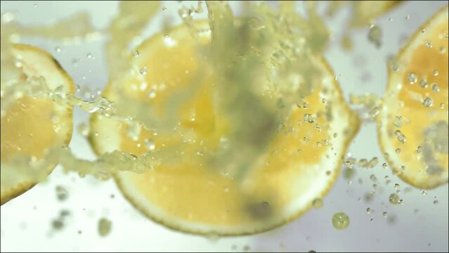 Super Slow Motion of Explosion Lemon and Burst Juice and Slices