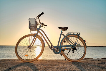 Fototapeta na wymiar Bicycle parked on the seaside promenade on beach