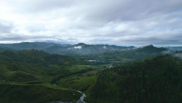 A cinematic bird's eye view of a small village in the distance in Malaybalay Bukdinon Philippines