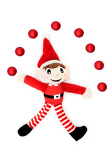 Fototapeta na wymiar Christmas elf juggling red bauble ball tree decorations, festive fun with santa helper on white background. Retro toy for the holiday season.