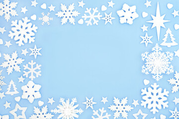 Festive magical snowflake star and heart Christmas background on pastel blue. Fantasy north pole...