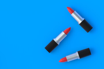 Scattered lipsticks. Cosmetic accessories. Make-up tools. Copy space. Flat lay. 3d render