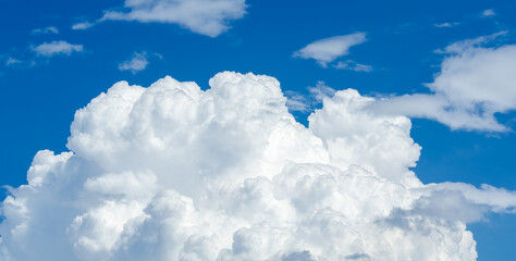 Naklejka na ściany i meble Fluffy white cumulus clouds in a blue sky on a beautiful day, natural soft background with copy space for text