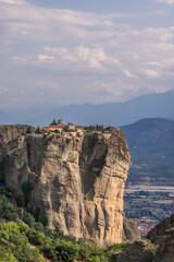 Fototapeta na wymiar Vertical shot of the Monastery of St. Stephen situated on the top of a rocky precipice 575 meters (1886 ft) in height, a little aside from the others. Meteora, Greece
